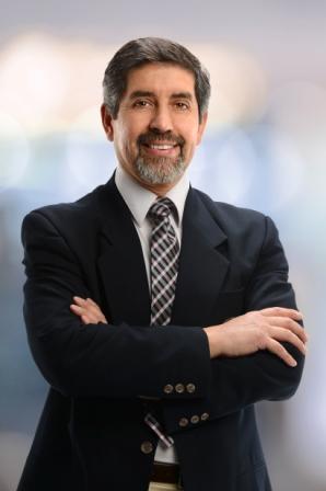 Portrait of Hispanic businessman smiling isolated over white background
